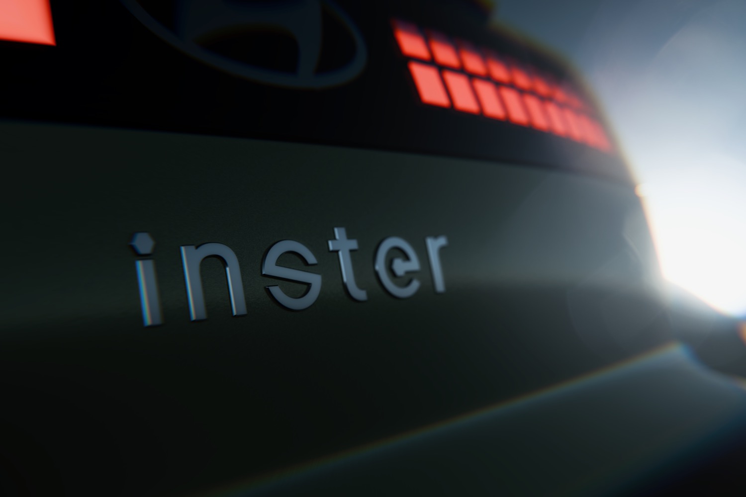 Teaser image showing the badge and taillights of the Hyundai Inster.