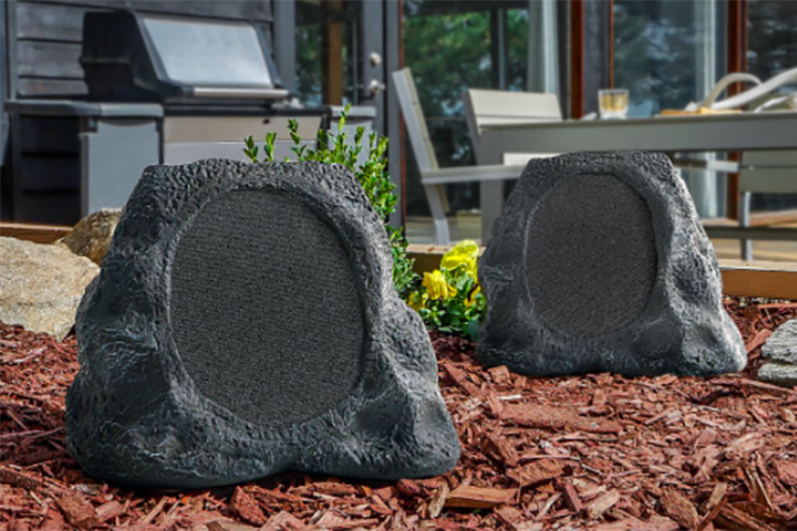 Two Victrola Rock Speaker Connects in a garden.