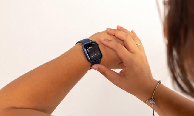 A woman looks at her Apple Watch with Dexcom G7 real-time glucose monitoring.