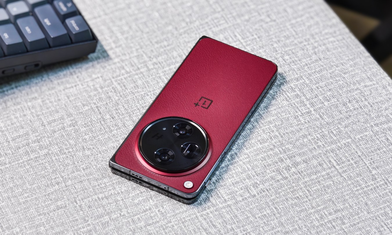 OnePlus Open Apex Edition Crimson Shadow red resting on a gray table.