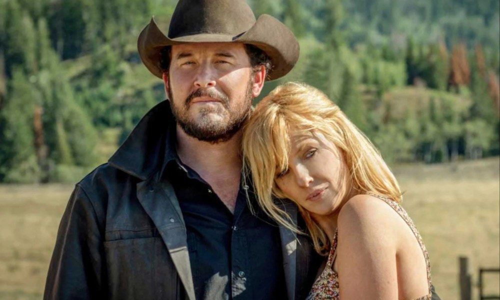 A woman puts her head against a man's shoulder in Yellowstone.