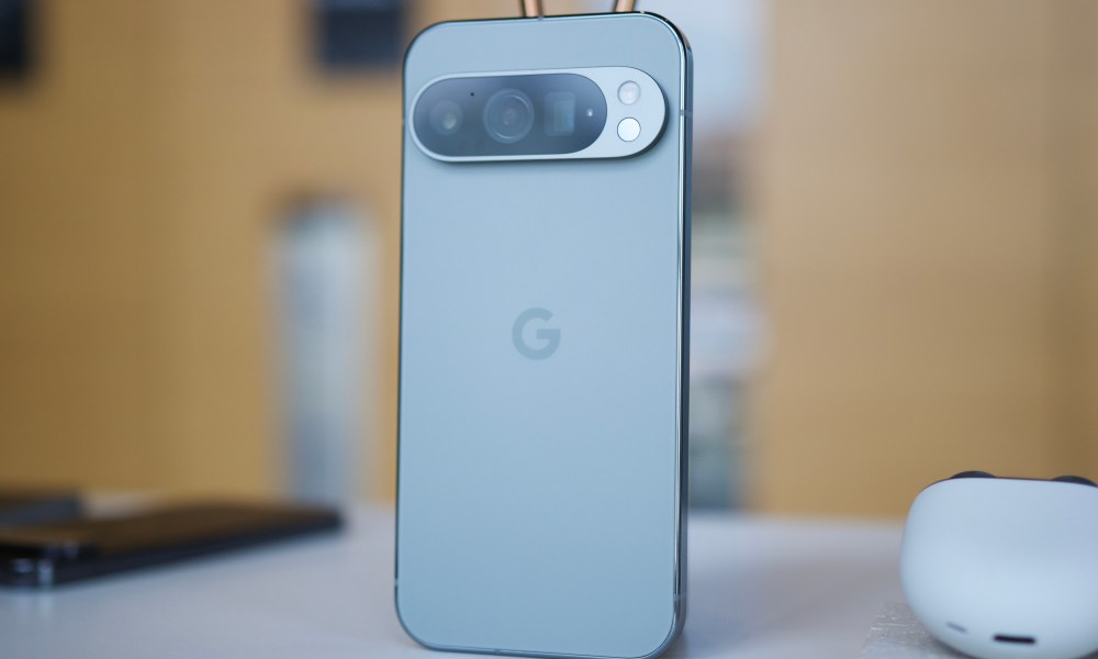 The Google Pixel 9 Pro standing upright on a table.