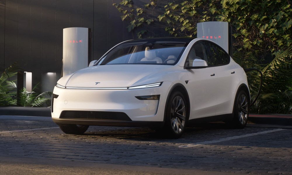 White Tesla Model Y Juniper at a Supercharger