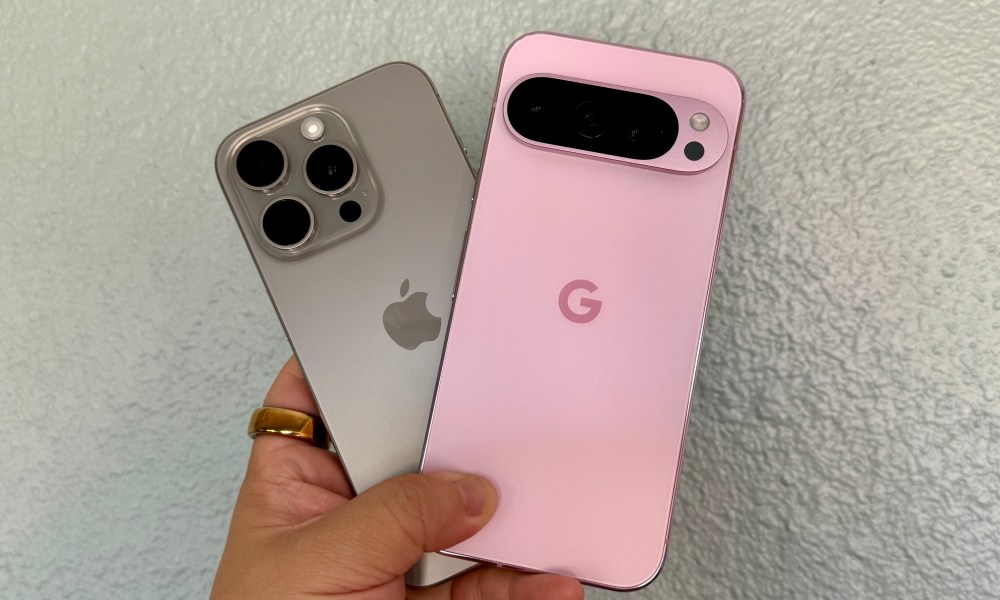 Someone holding an iPhone 15 Pro and a Pixel 9 Pro.