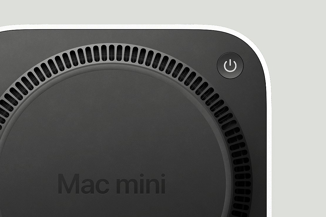 The underside of the M4 Mac mini, showing its vent and power button.