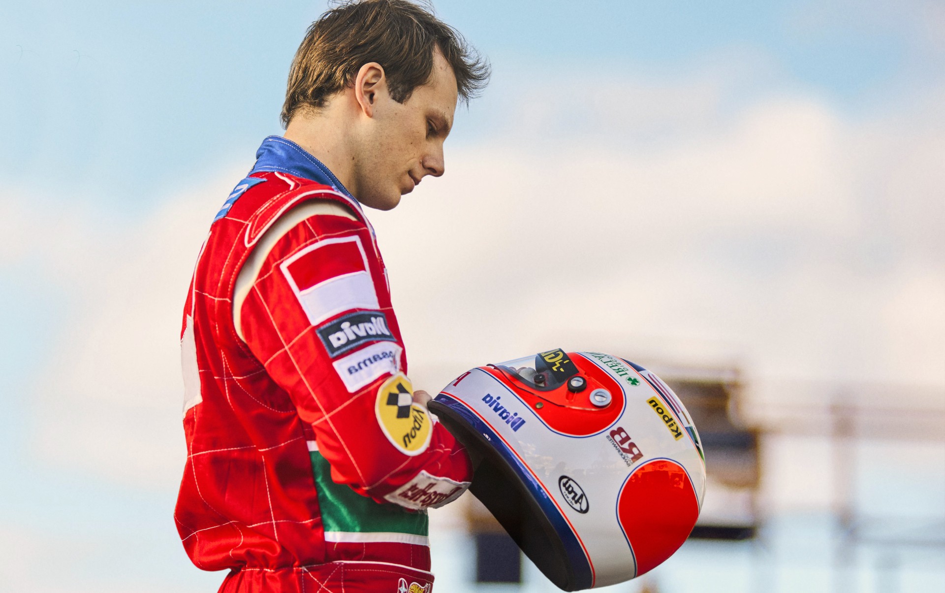 A man holds a helmet in Senna.