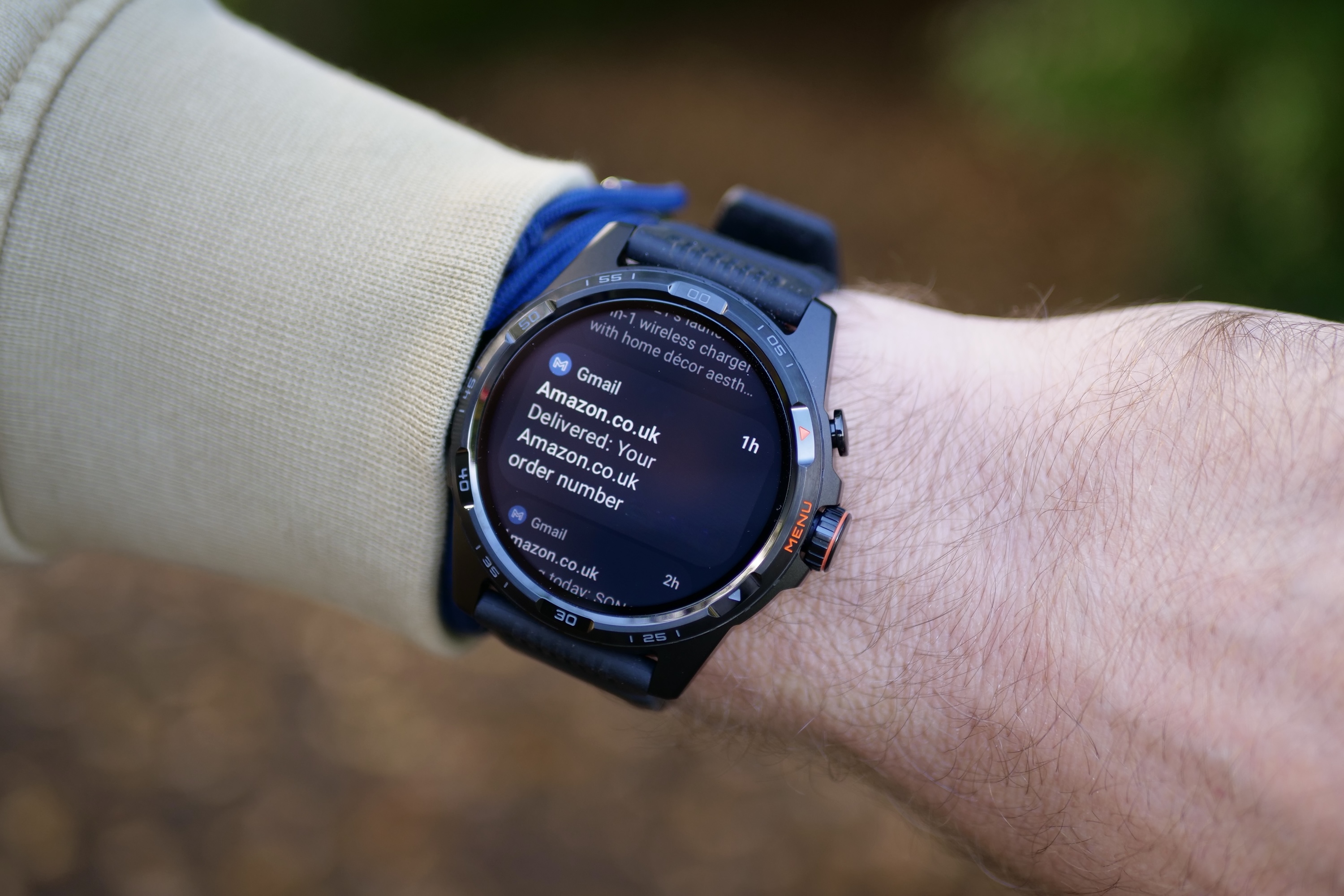 A person wearing the Mobvoi TicWatch Atlas, showing a notification.