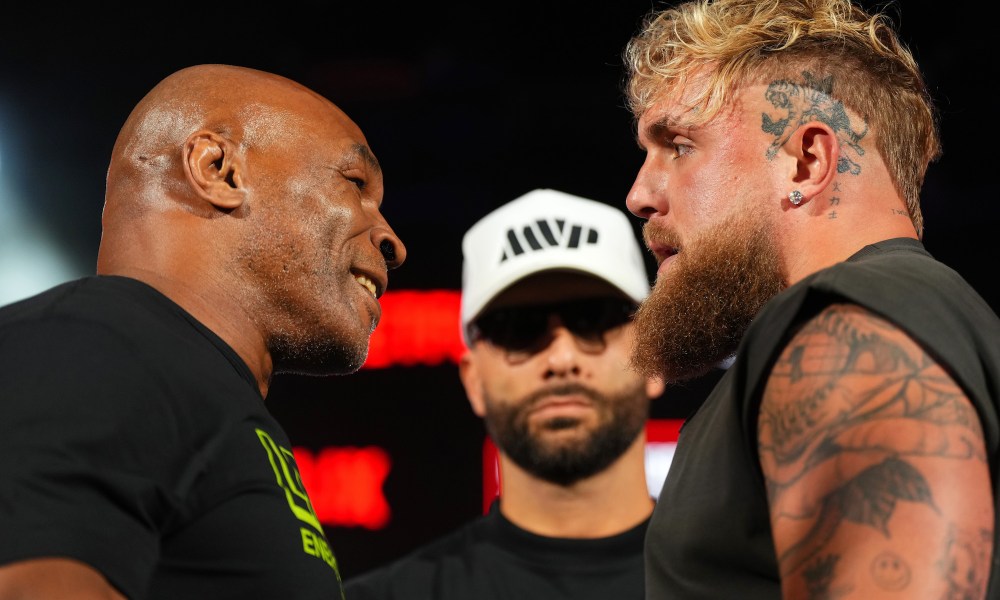 Mike Tyson and Jake Paul stare in a face-off.