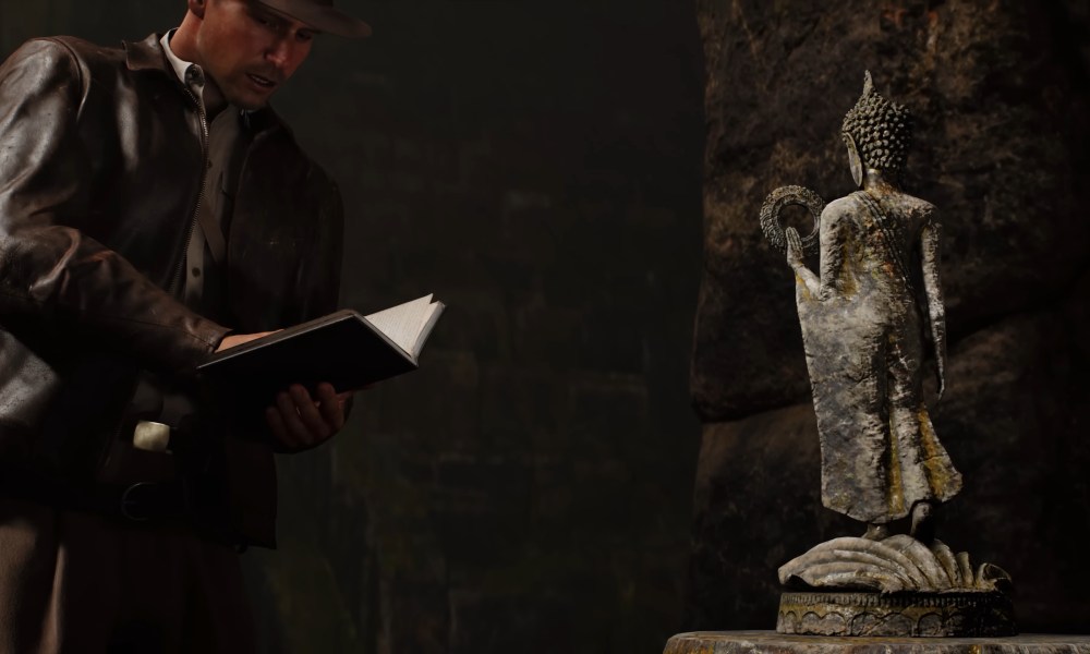 Indiana Jones journaling by a statue in Indiana Jones and the Great Circle.