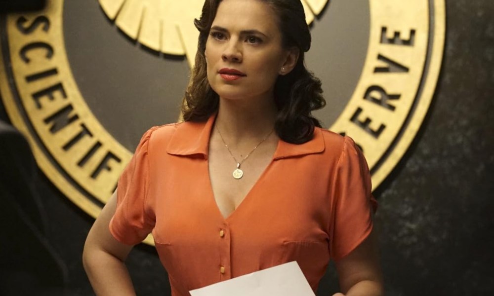 A woman holds a paper and stares in Agent Carter.