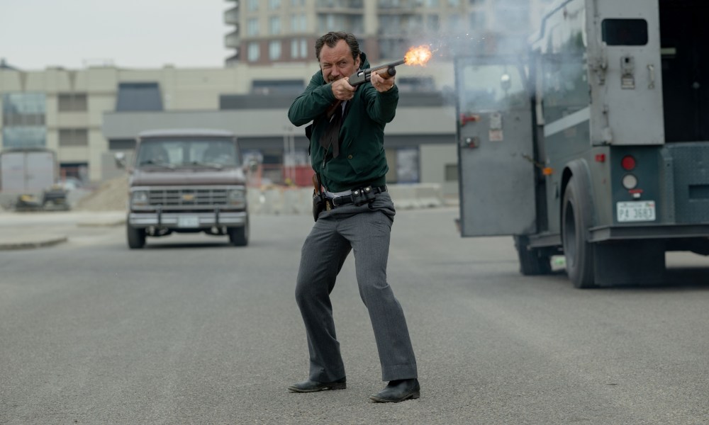 Jude Law fires a shotgun in The Order.