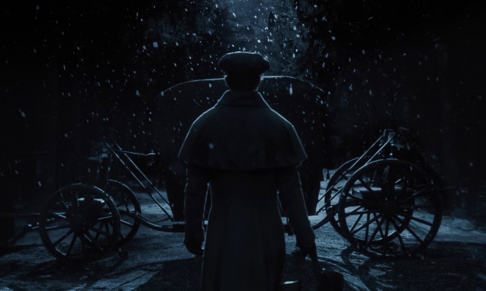 Nicholas Hoult stands in front of a carriage in Nosferatu.