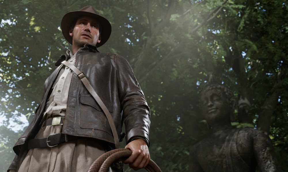 Indiana Jones standing in a forest with a whip.