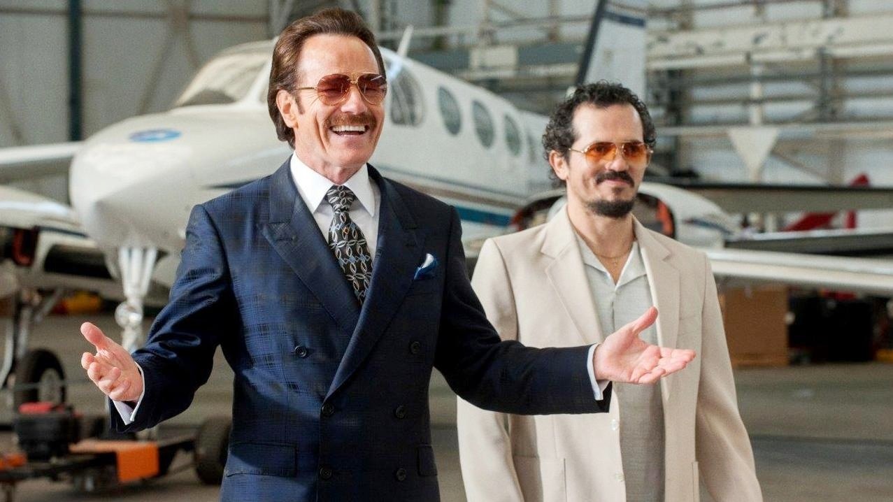 Two men stand in a hangar in The Infiltrator.