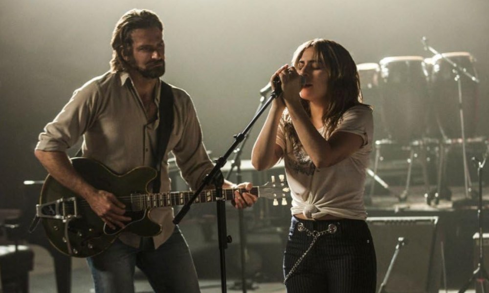 Bradley Cooper plays the guitar as Lady gaga sings in A Star Is Born.