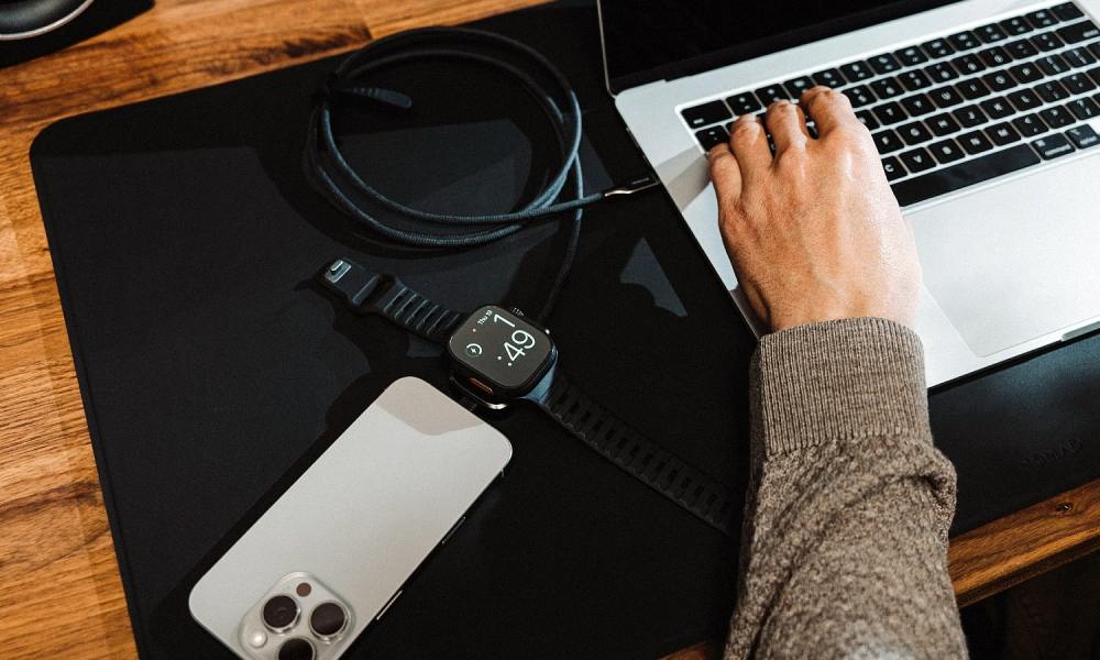 The Nomad Universal Cable for Apple Watch being used to charge Apple devices.