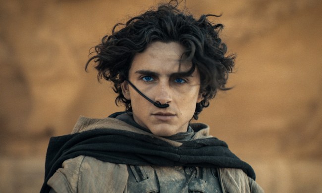 Timothee Chalamet staring at the camera, hair blowing in the wind in the desert in Dune.